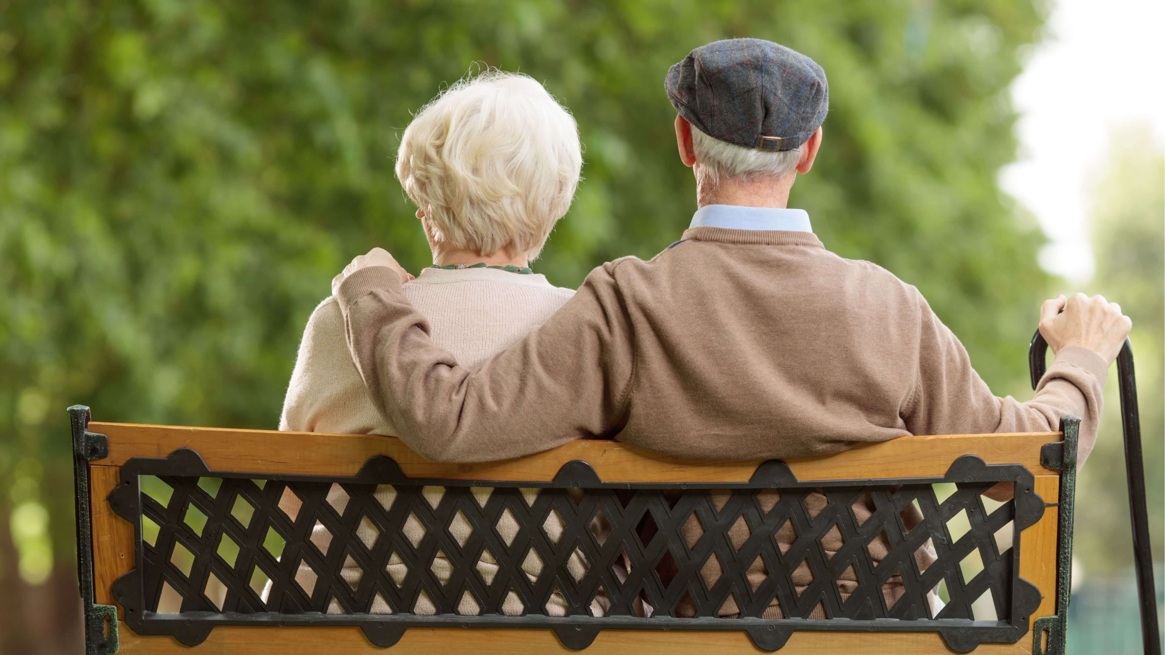 Senior couple sitting on a bench outdoors